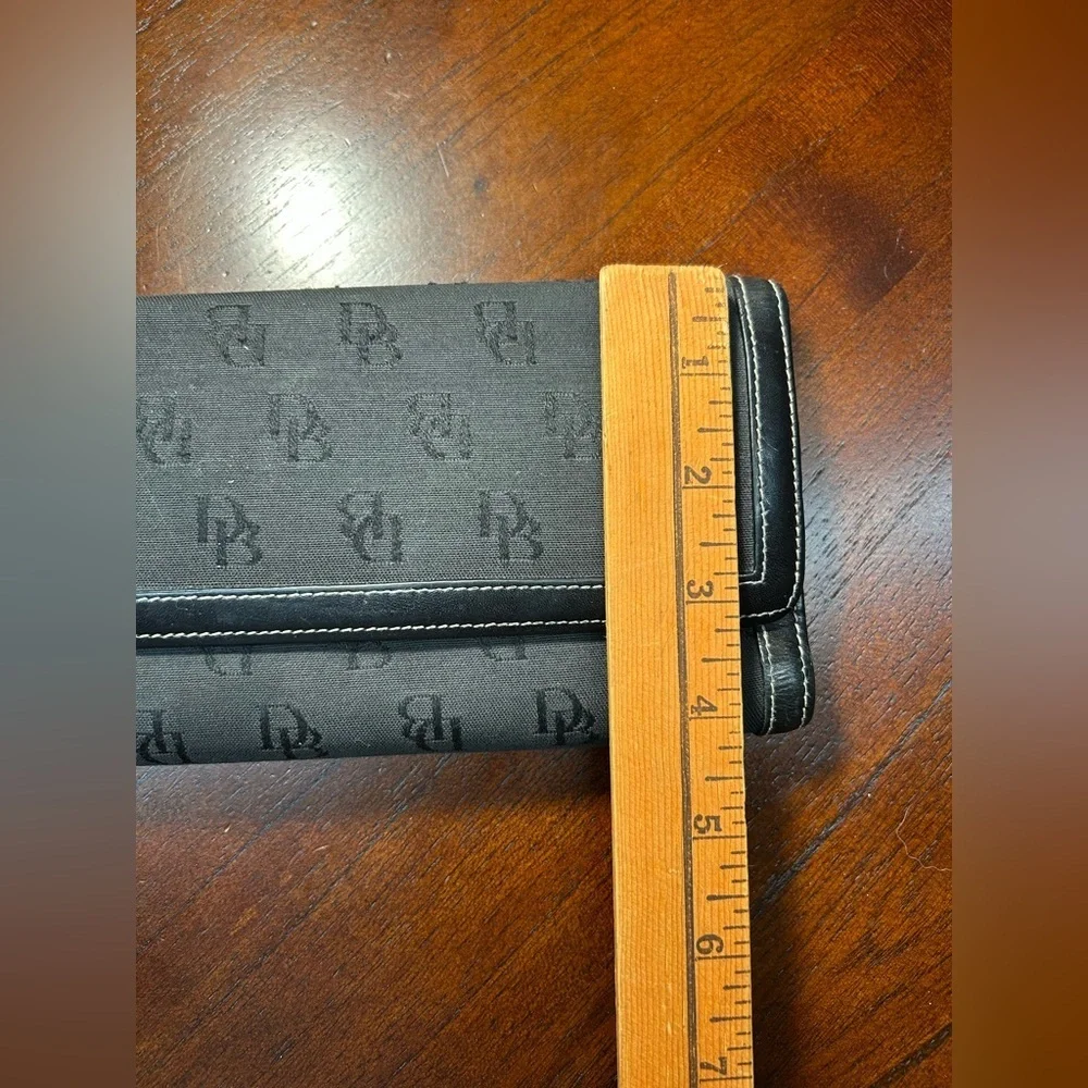Dooney & Bourke Black Logo Fold Wallet It has a small detail on the inside
